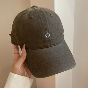 Brown cotton baseball cap with curved brim and embroidered circle detail