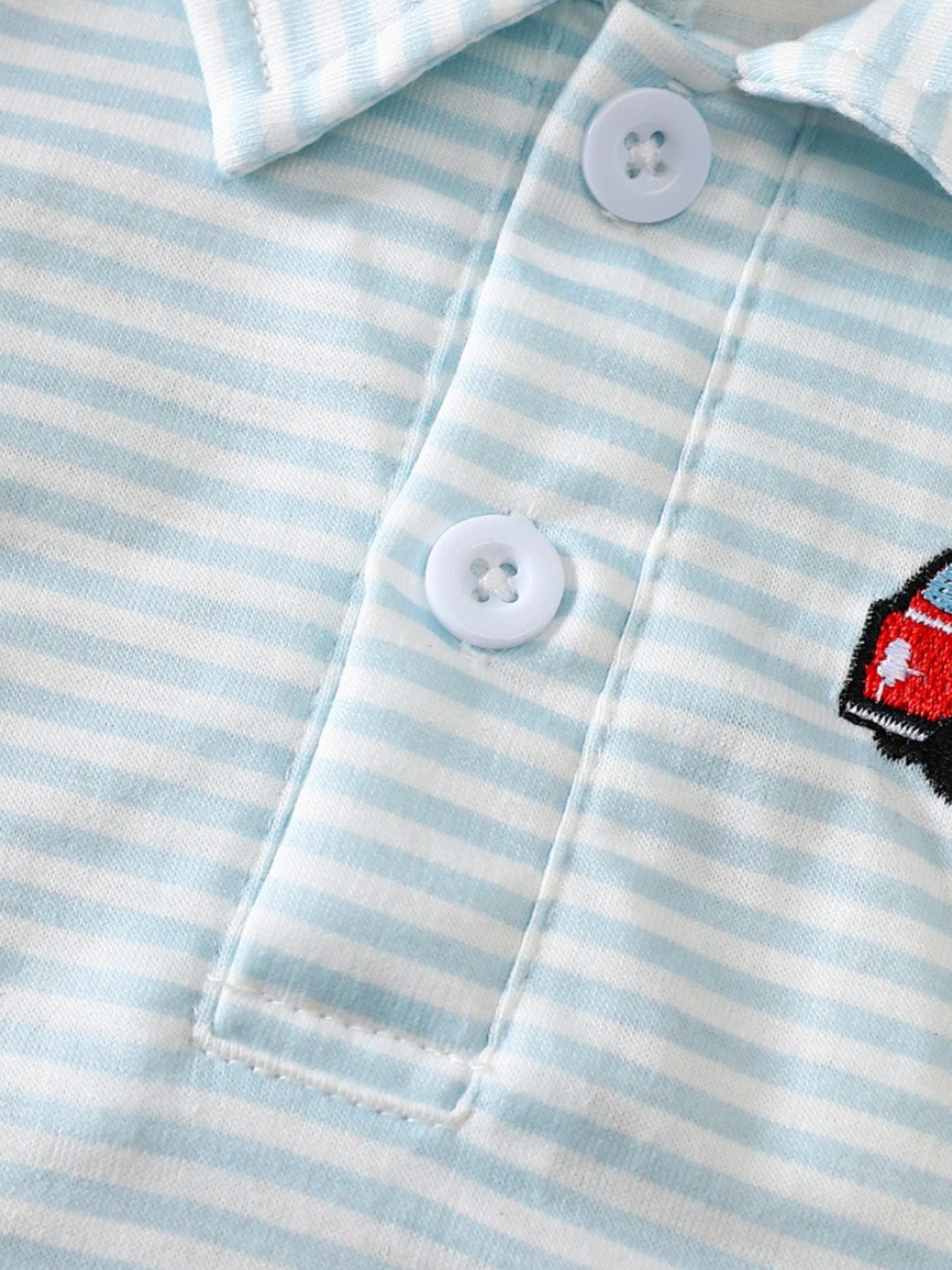 Baby polo shirt with blue and white stripes and embroidered firetruck detail.