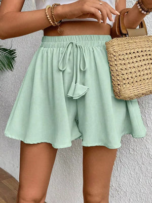 Green cotton chino shorts with drawstring waist and A-line cut.