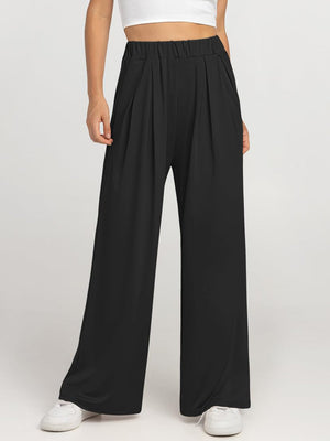 Black pleated palazzo trousers with pockets and elastic waist.
