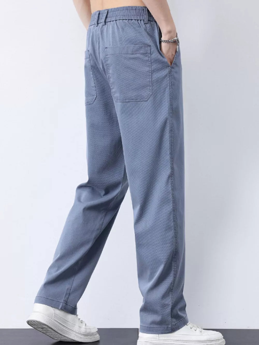 Relaxed fit light blue cargo pants with elastic waist and back pockets.