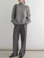 Gray acrylic turtleneck sweater with dropped shoulders and ribbed cuffs and hem.