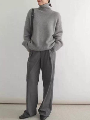 Gray acrylic turtleneck sweater with dropped shoulders and ribbed cuffs and hem.
