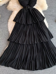 Black pleated midi dress with tiered skirt and belted waist