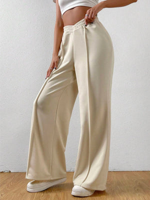 Cream V-waistline palazzo sweatpants with center seams and elastic waistband.
