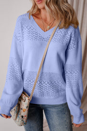 Light blue perforated knit v-neck pullover sweater with allover openwork pattern.