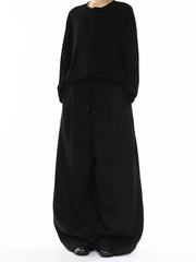 Men's black wide-leg drawstring sweatpants with pockets.