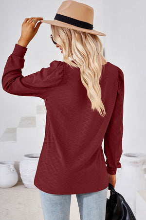Burgundy diamond-textured puff sleeve top with long sleeves.
