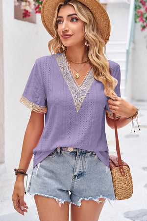 Lavender eyelet blouse with lace trim V-neck and short sleeves.