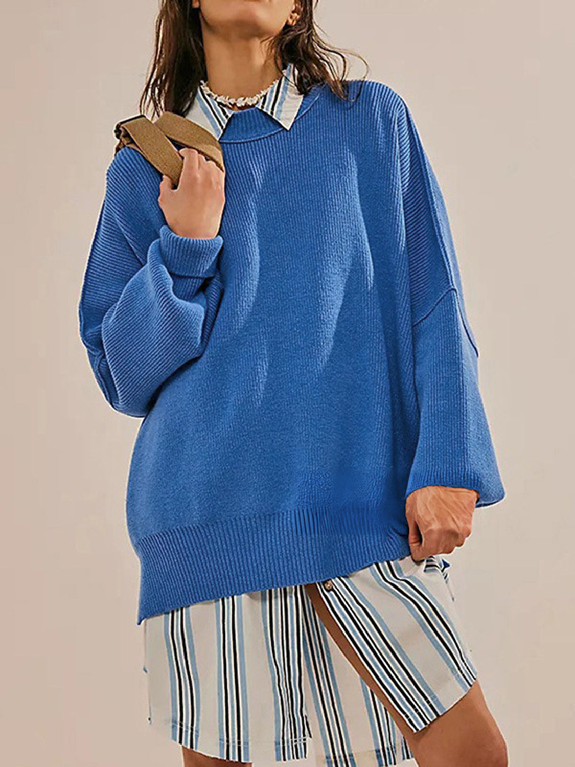 Oversized royal blue ribbed knit sweater with drop shoulders and wide sleeves.