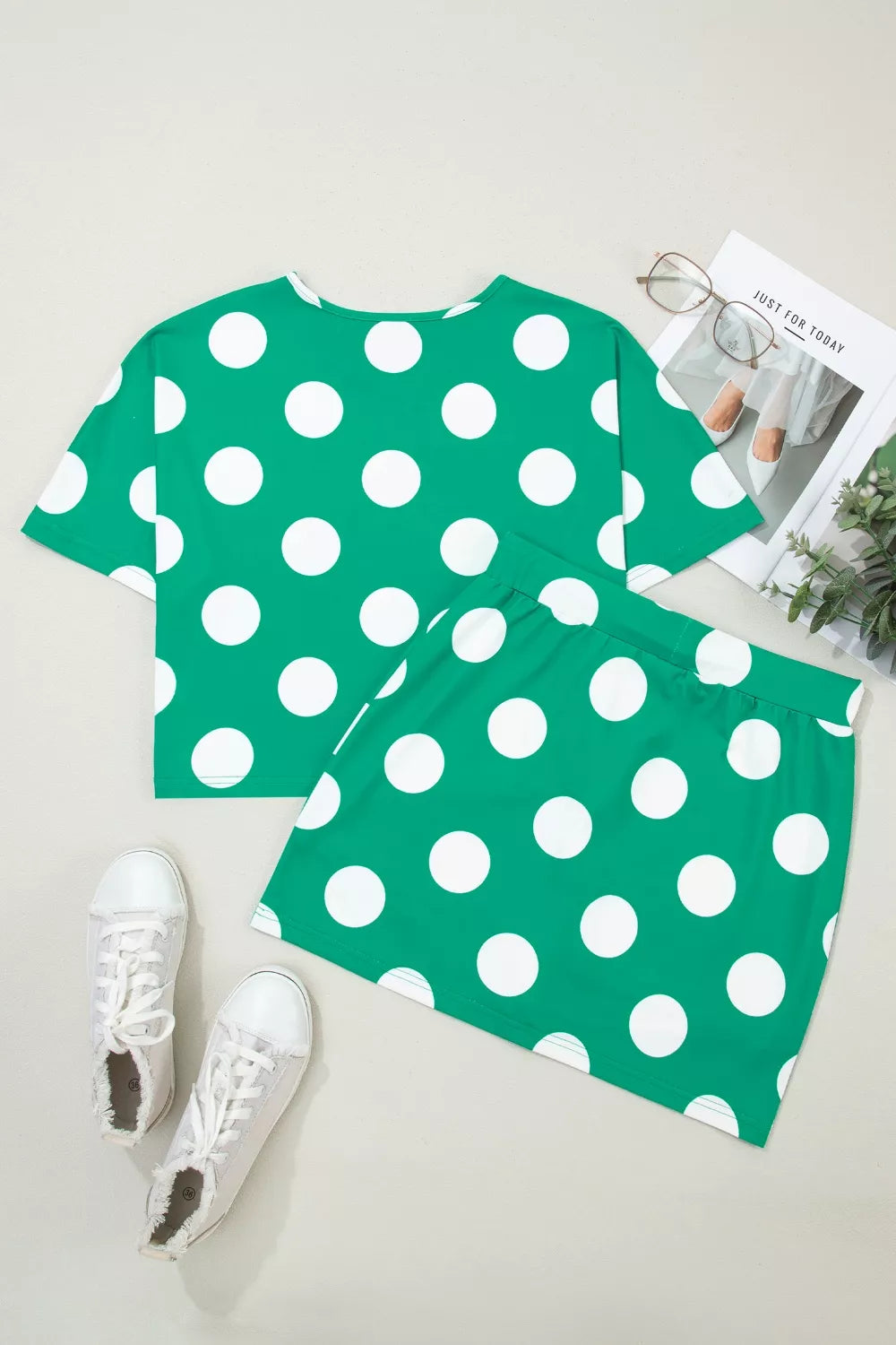 Green polka dot cropped tee and skort set with drawstring detail.