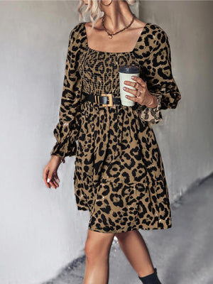 Smocked bodice leopard print mini dress with square neckline and long sleeves.