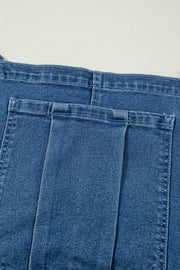 Medium wash denim wide-leg overalls with buttoned front and adjustable straps.