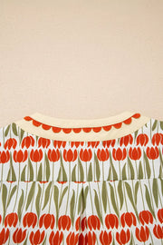Cotton mini dress with vibrant red tulip print, cream collar, and scalloped trim.