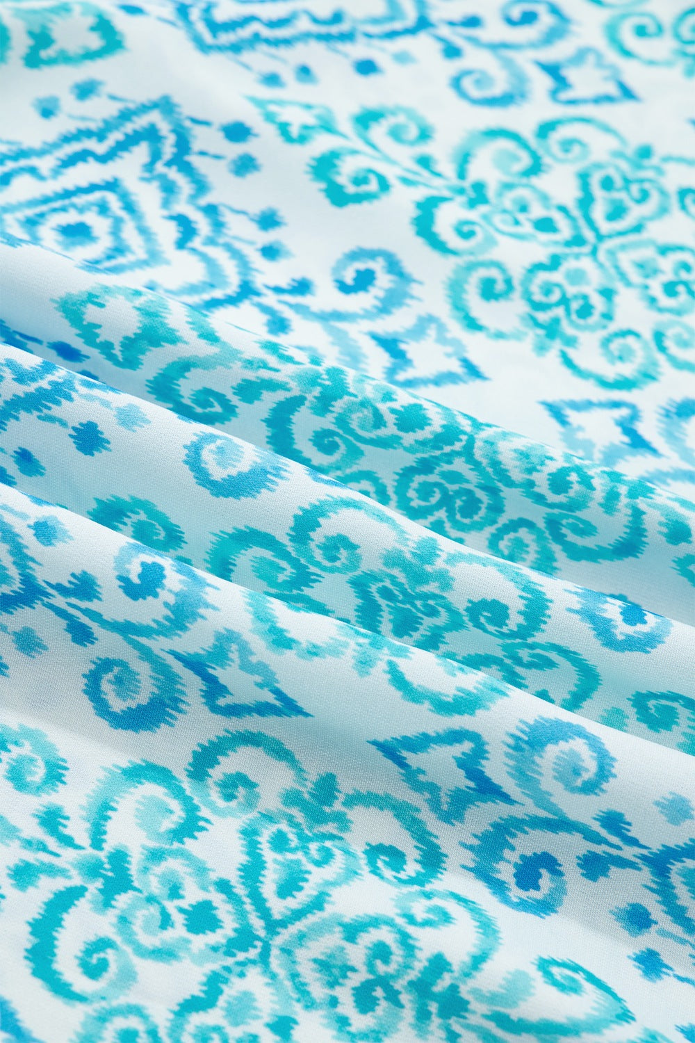 Patchwork ruffle mini dress in blue with ornate ikat print fabric detail