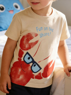 Beige cotton toddler tee with a playful lobster graphic and "Fun on the shore!" text.