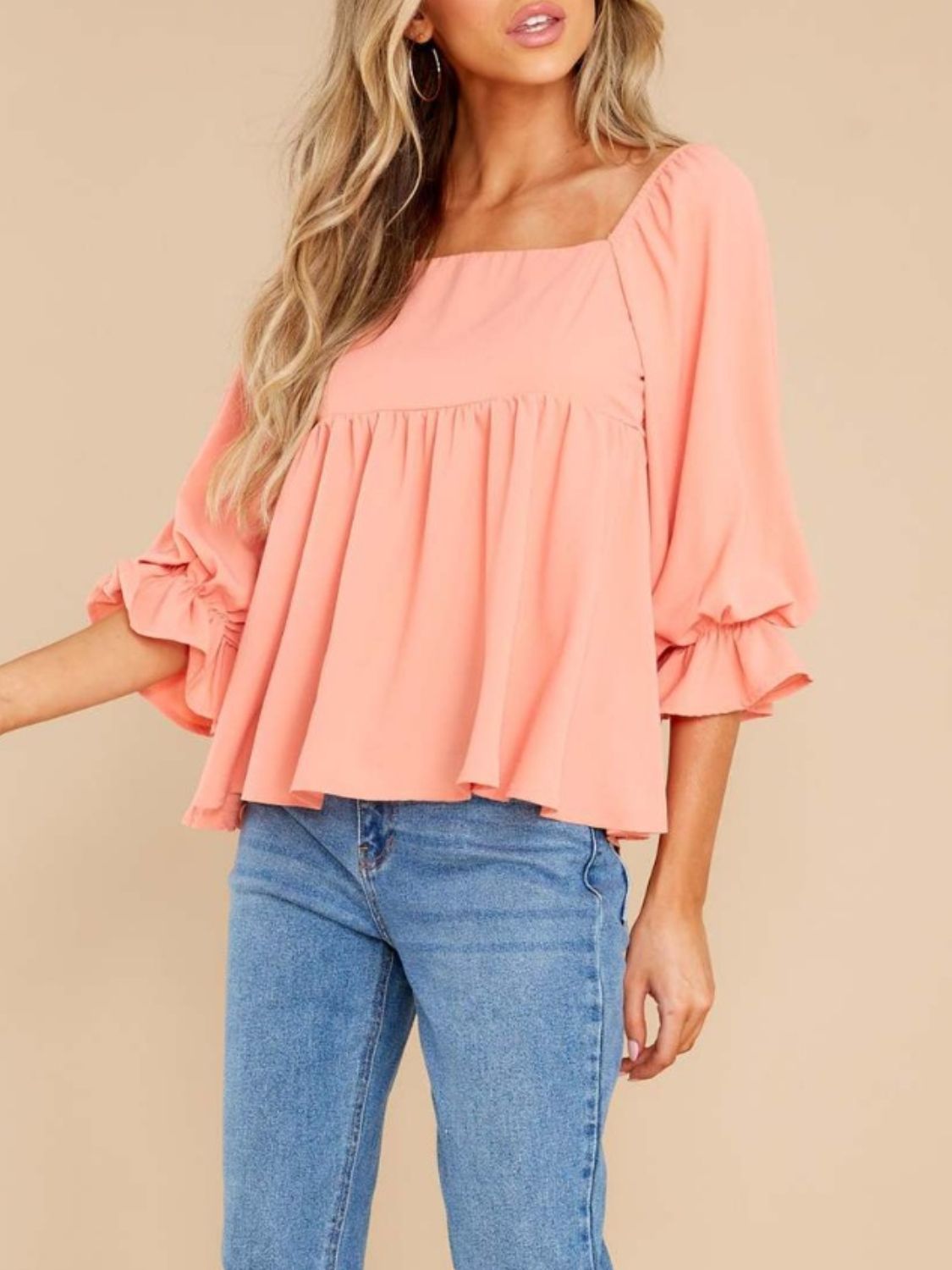 Watermelon pink babydoll blouse with square neckline and ruffled bell sleeves.