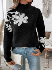 Black mock neck knit sweater with white floral embellishments and subtle sparkle detail.