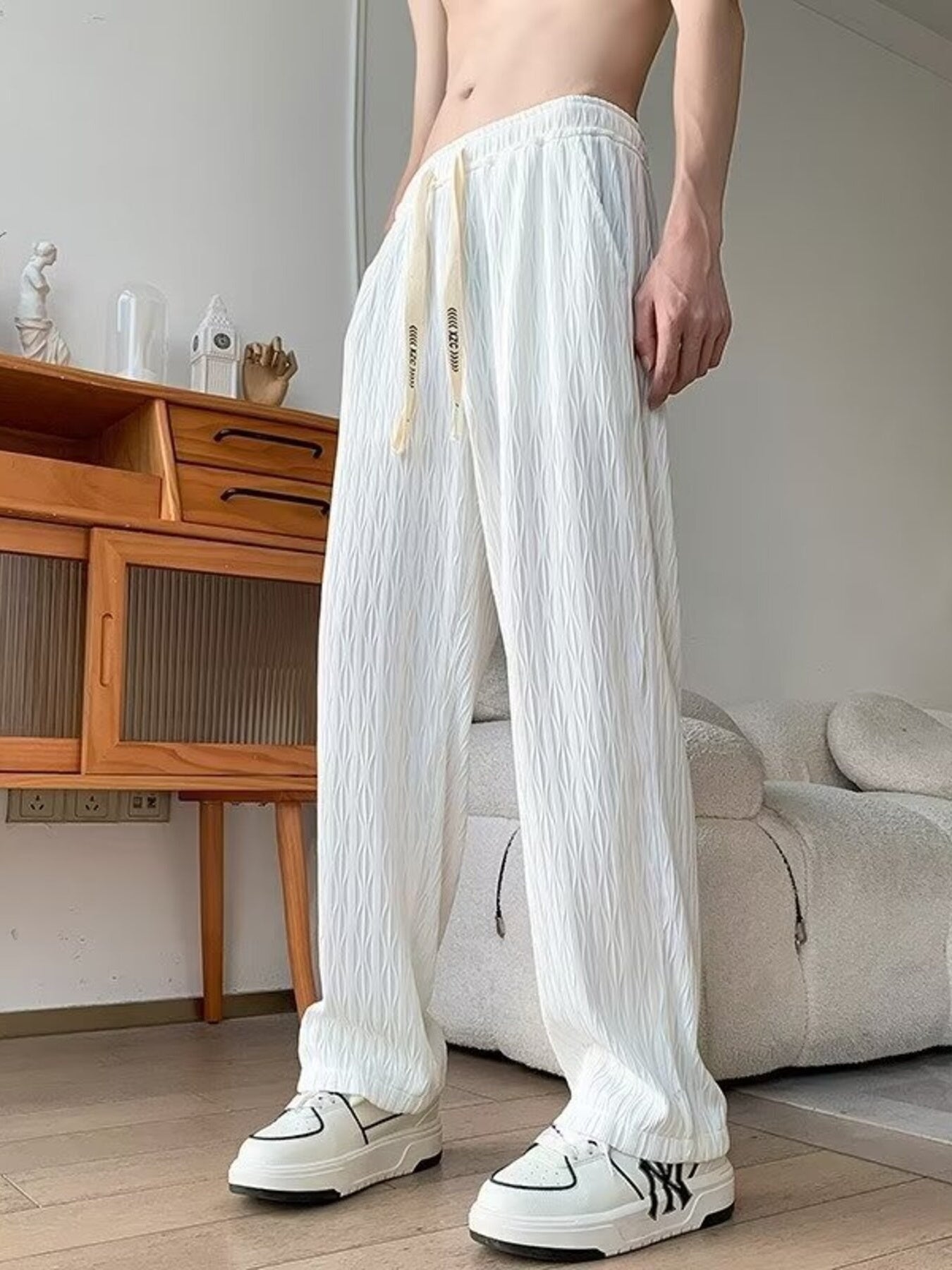 White textured wide-leg drawstring sweatpants with a relaxed fit and subtle diamond pattern.