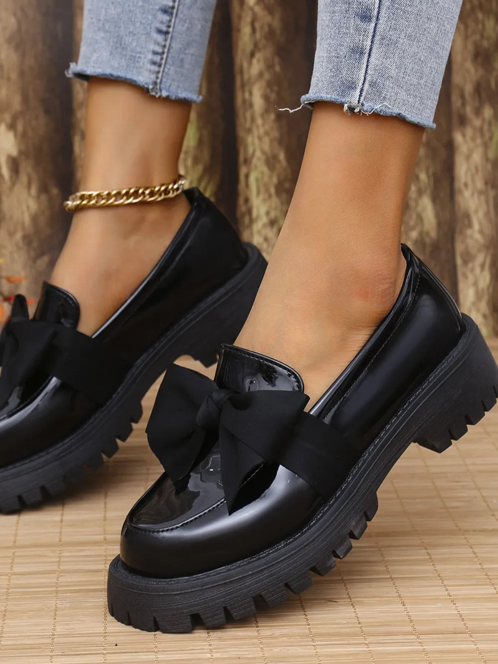 Black patent platform loafers with bow detail and chunky sole