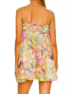 Ruffled floral mini dress with tie straps and a yellow floral print.