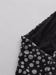 Black polka dot halter maxi dress detail showing mesh fabric and neckline.