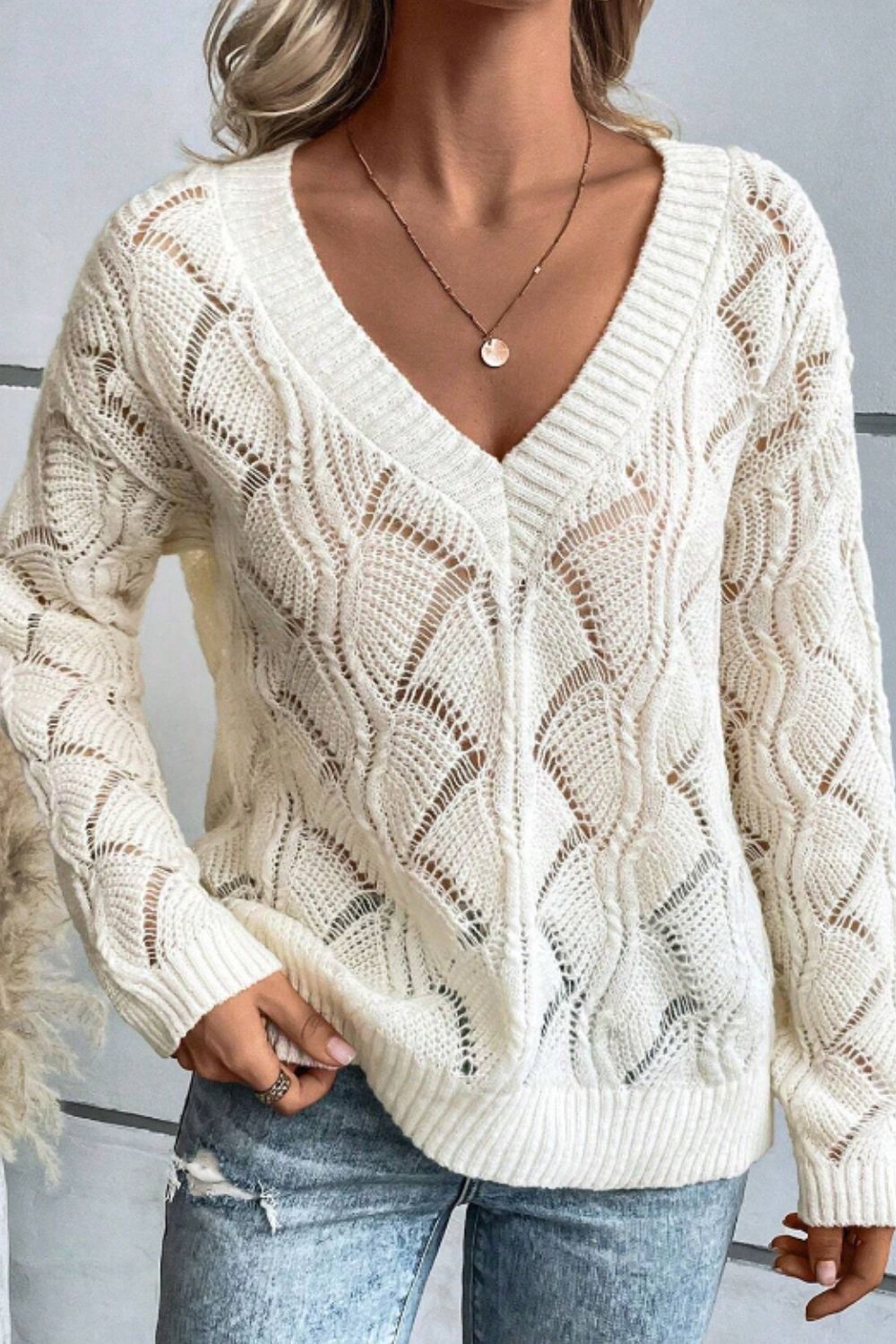 Ivory openwork knit V-neck pullover sweater with diamond pattern detail.