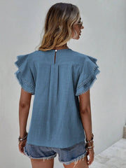 Dusty Blue ruffle sleeve blouse with pom-pom trim and keyhole back detail.