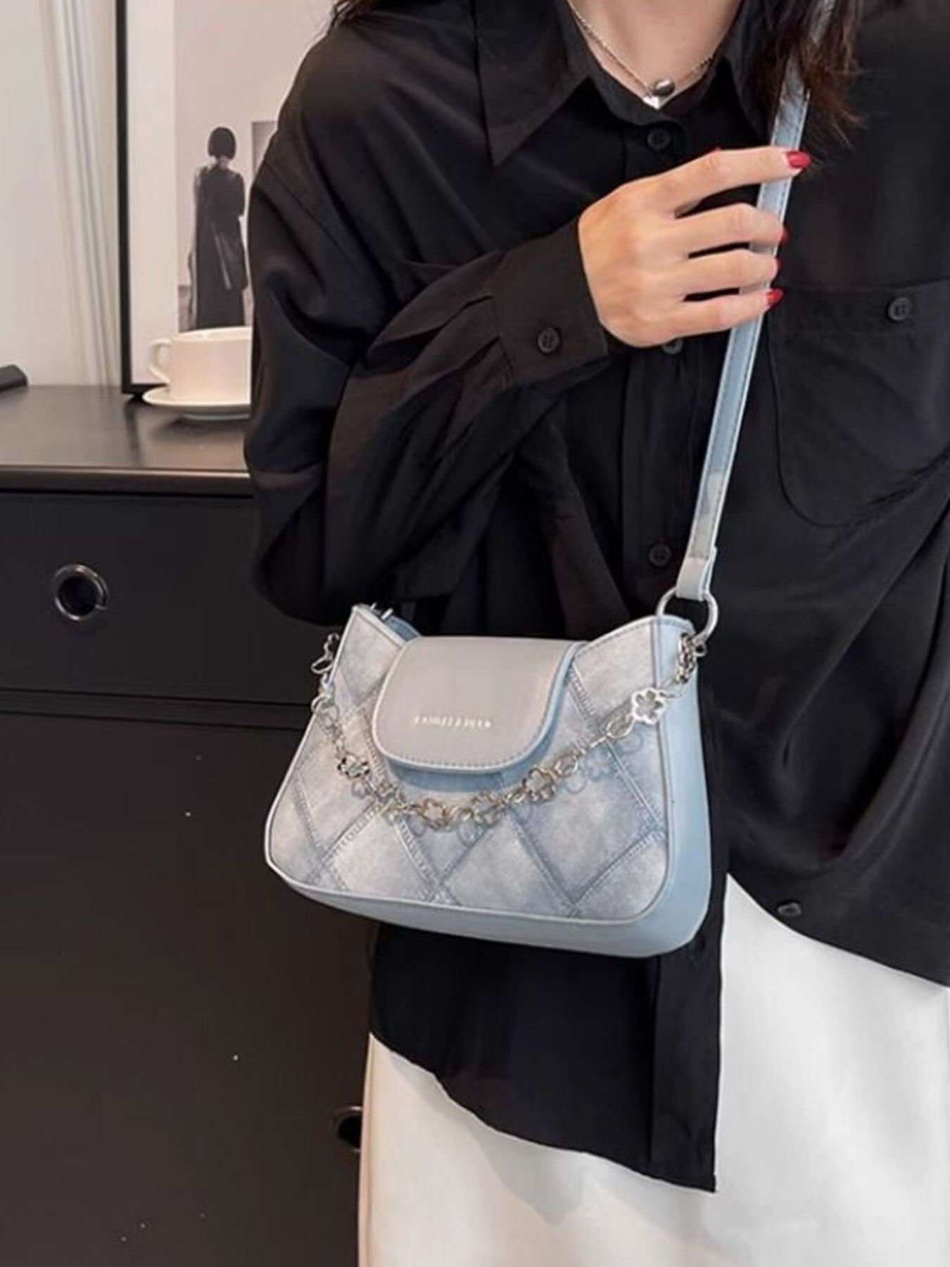 Textured blue shoulder bag with chain strap and quilted detail