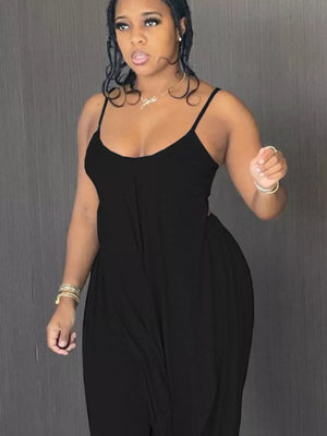 Black cami and wide-leg pants set with asymmetrical draped hem.