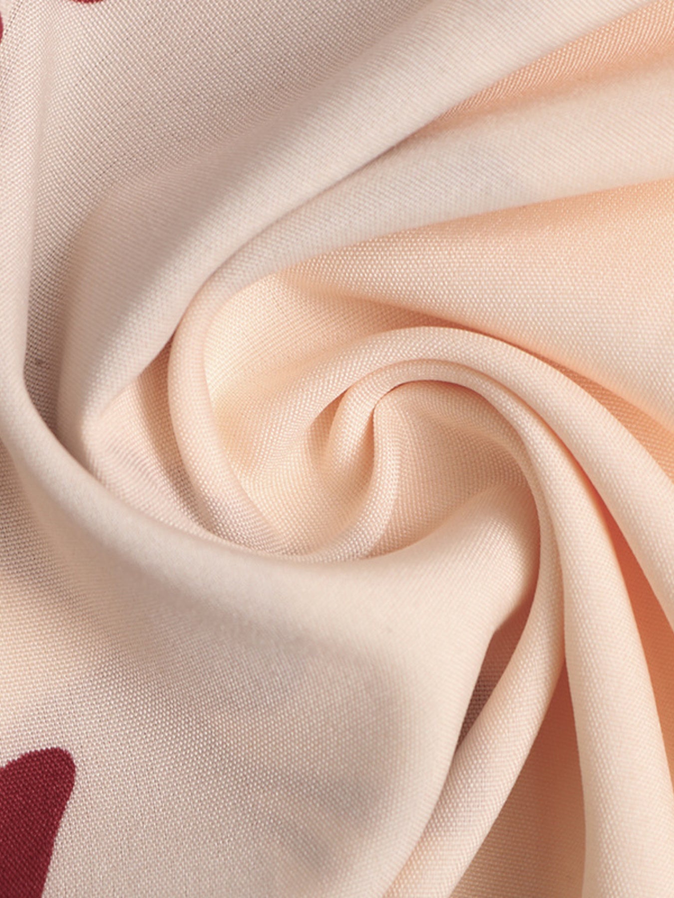 Floral maxi dress fabric detail in light peach with a deep v-neck and a-line cut.