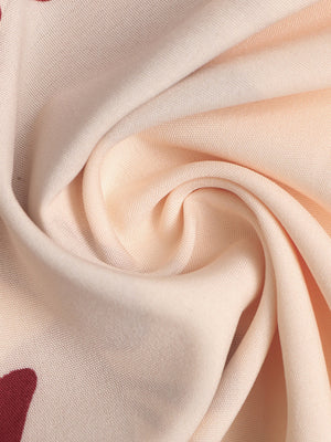 Floral maxi dress fabric detail in light peach with a deep v-neck and a-line cut.