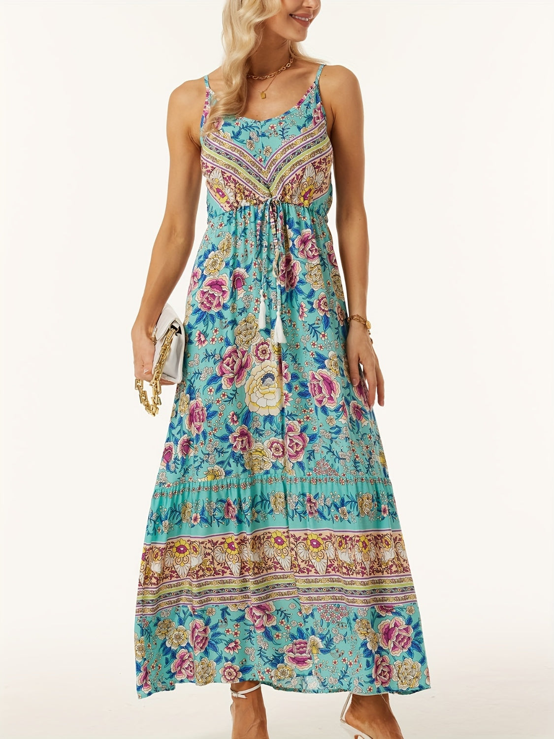 Turquoise bohemian floral maxi dress with adjustable waist and tassel detail.