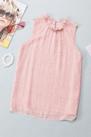 Blush pink sleeveless blouse with ruffled neckline and allover abstract print.
