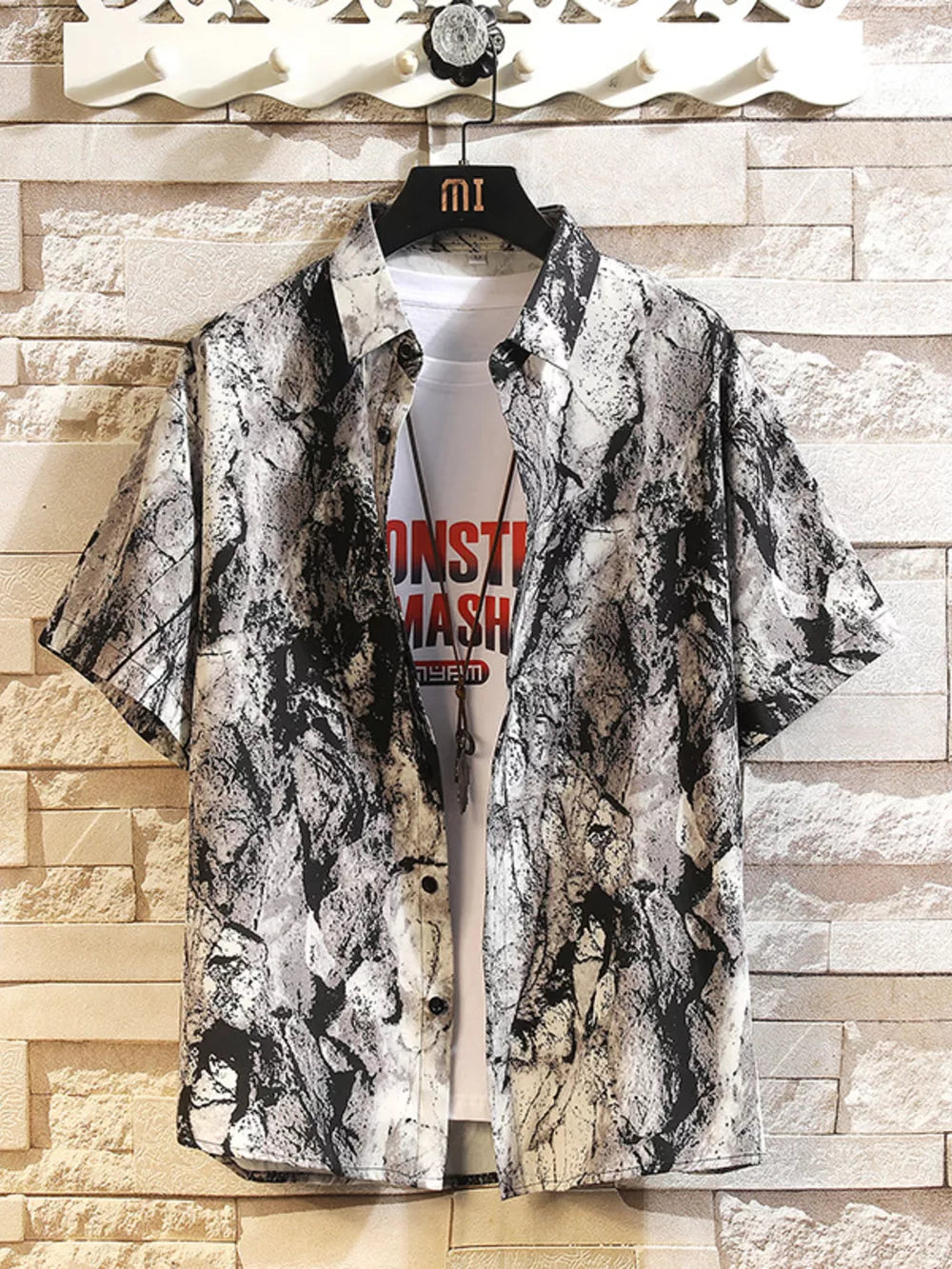 Men's short-sleeve collared shirt with abstract print in dark gray and white.