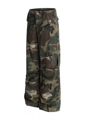 Distressed camouflage cargo pants for men with ripped details and visible stitching.