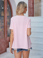 Perforated blush pink jacket with short sleeves and a relaxed fit.