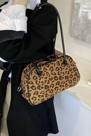 Caramel leopard print barrel bag with black trim and handles
