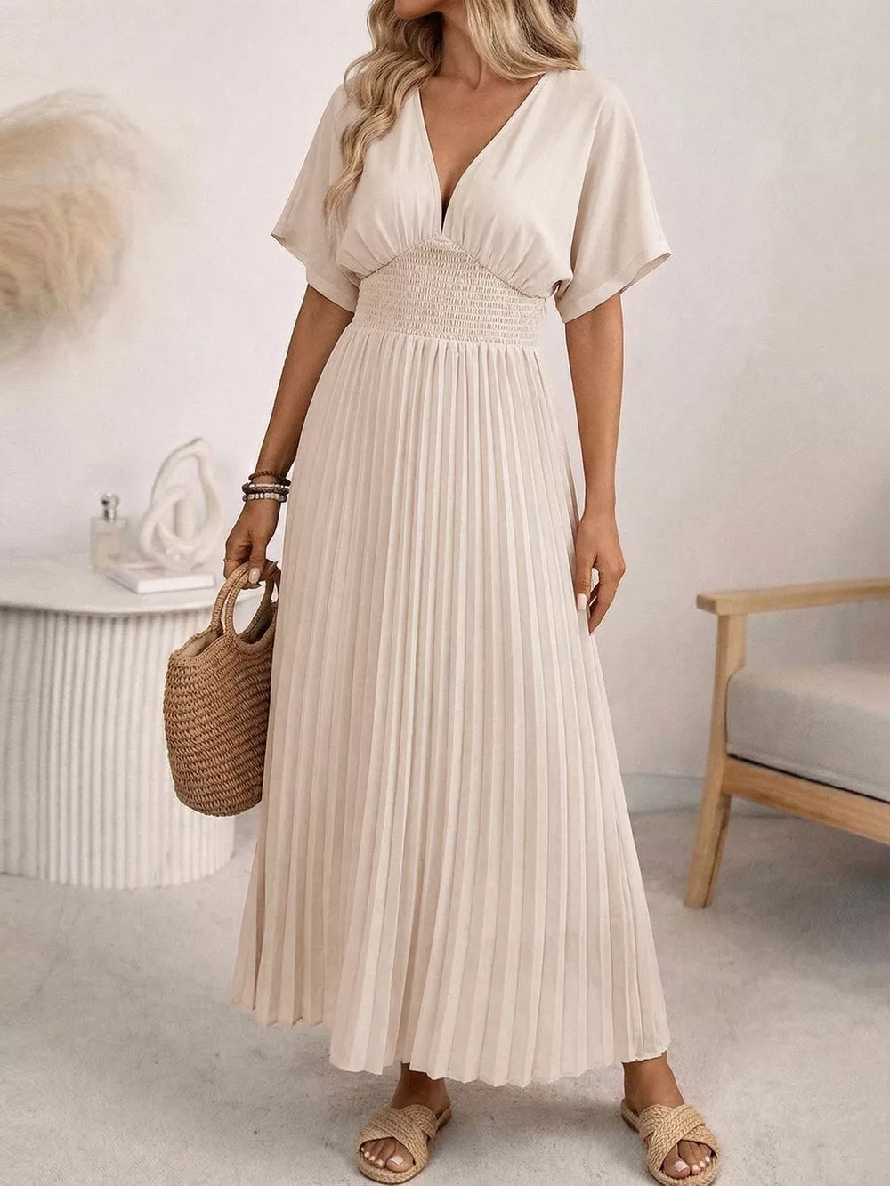 Apricot V-neck midi dress with short sleeves, smocked waist and pleated skirt.