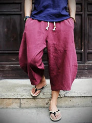 Men's wine red relaxed fit cropped sweatpants with drawstring and pockets.