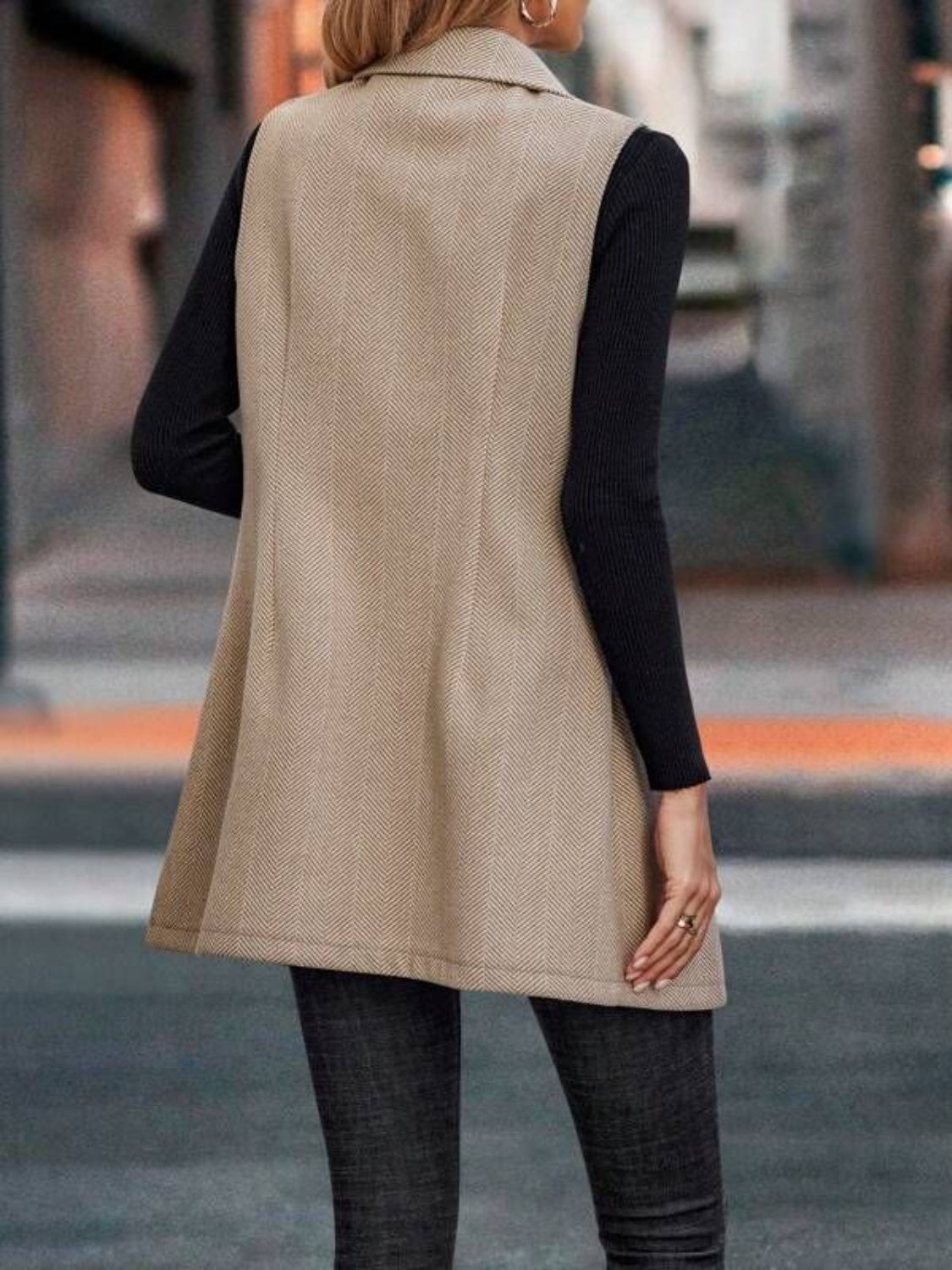 Khaki herringbone tailored vest with a collared neckline and double-breasted front.