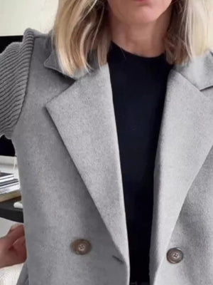 Light gray double-breasted trench coat with knit sleeves and button detail