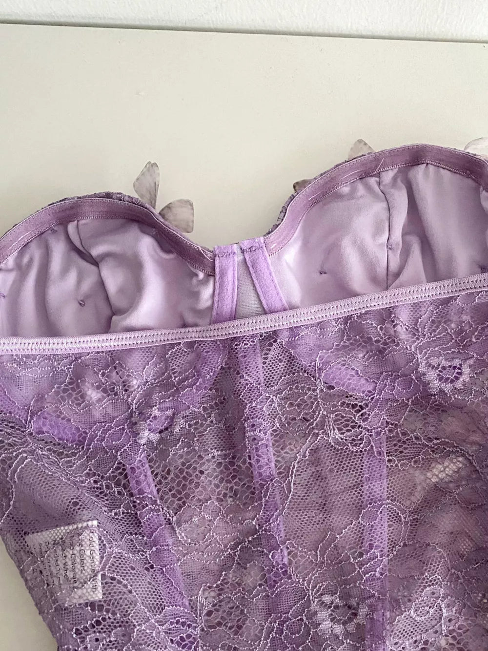 Lavender lace bustier top with 3D butterfly appliques and a bow detail.