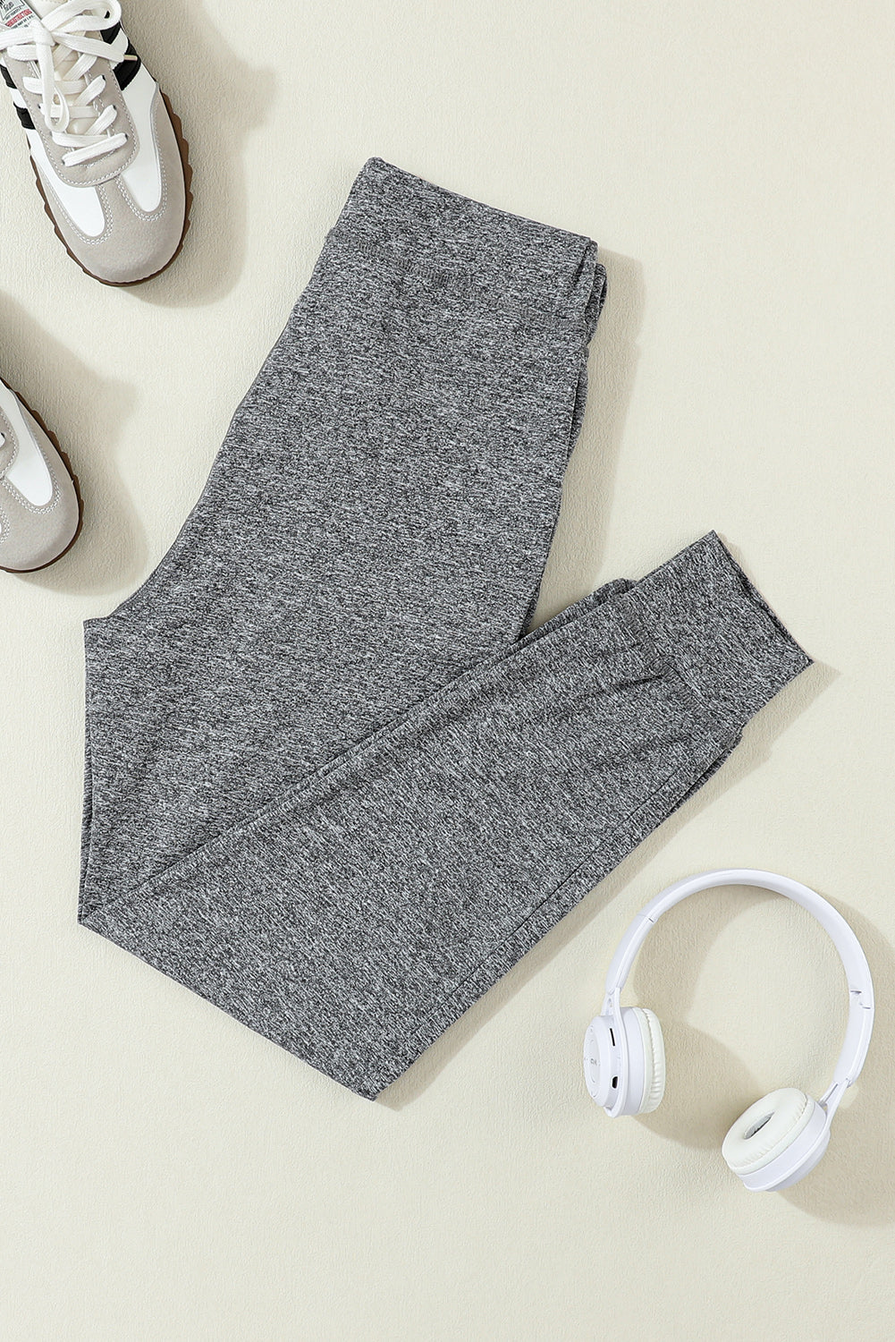 Slim-fit heather gray joggers with drawstring and cuffed ankles.
