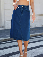 Dark blue denim midi skirt with panel seams and pockets.
