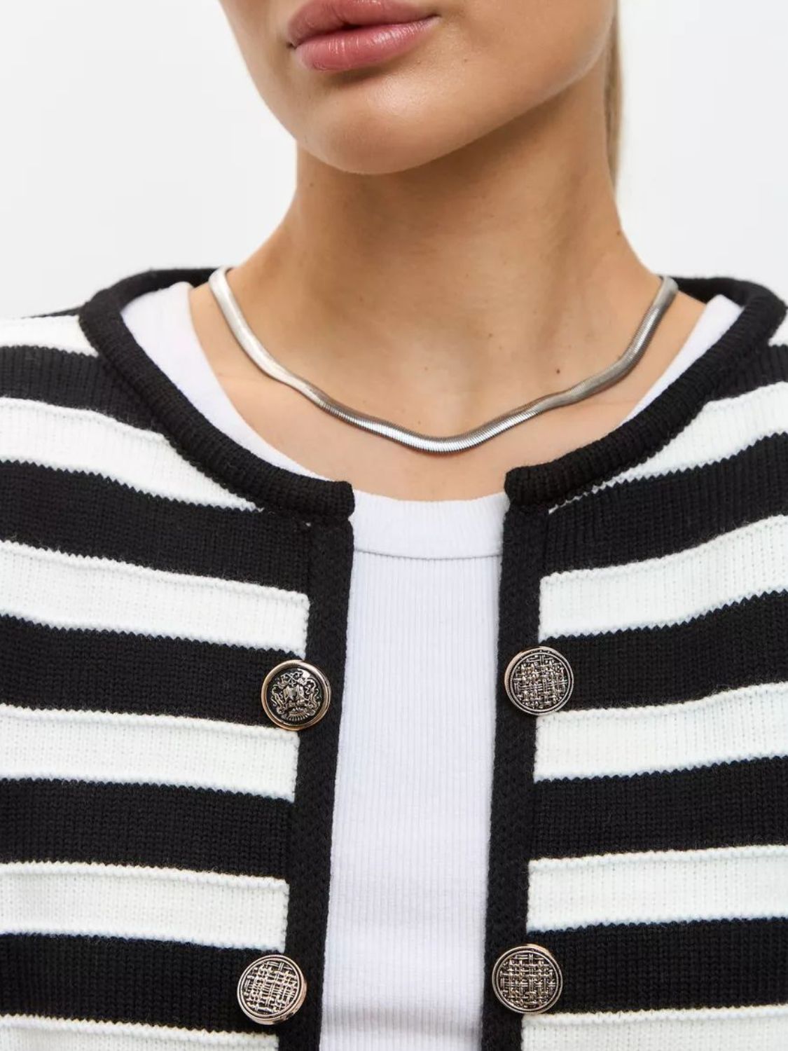 Black and white striped knit button-up cardigan with ornate buttons