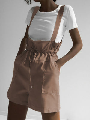 Camel high-waisted drawstring suspender shorts with pockets, styled with a white t-shirt.