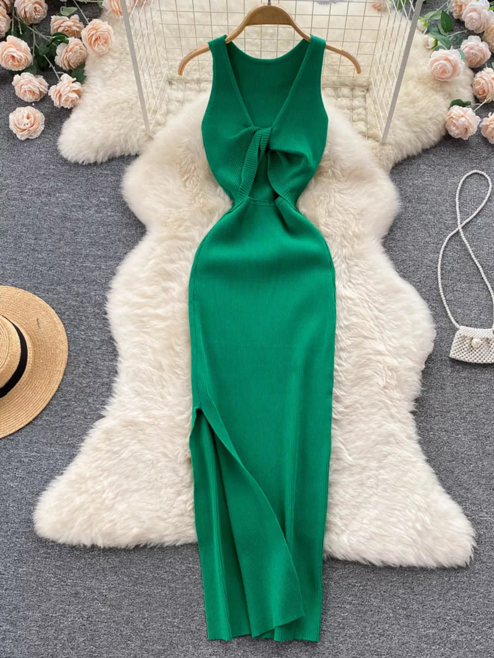 Emerald green ribbed knit midi dress with knot-front cutout and side slit.