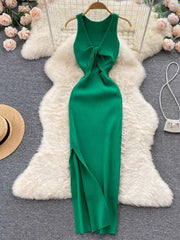 Emerald green ribbed knit midi dress with knot-front cutout and side slit.