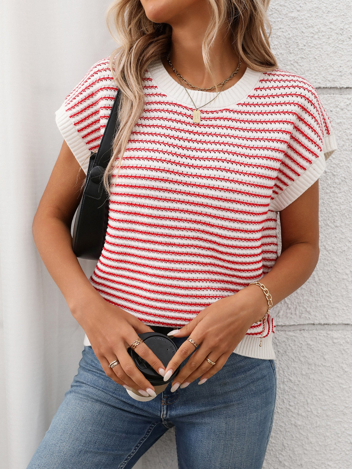 Horizontal stripe knit shell top in red and white with a crew neck and short sleeves.